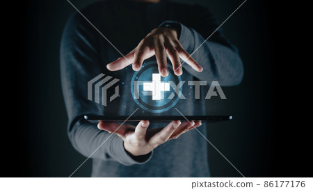Man holding tablet with the medical cross symbol on the virtual display. life insurance, Medical care, and Healthy business. World Health Day. Man holding tablet with the medical cross symbol on the virtual display. life insurance, Medical care, and Healthy business. World Health Day. 86177176