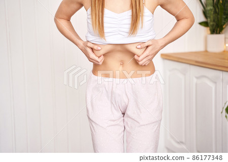 Young pretty woman do breathing exercise. Home sport workout. Healthy lifestyle Young pretty woman do breathing exercise. Home sport workout. Healthy lifestyle 86177348