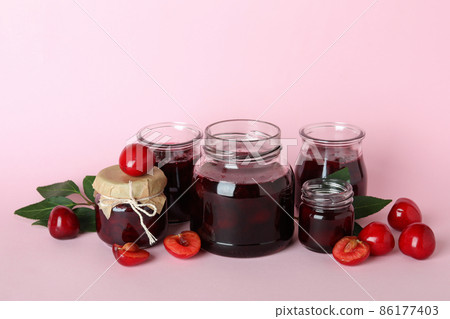Cherry jam and ingredients on pink background 86177403