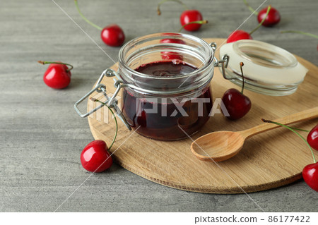 Cherry jam and ingredients on gray textured table 86177422
