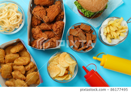 Concept of fast food on blue background Concept of fast food on blue background 86177495