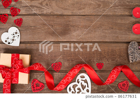 gift box and red ribbon with tag on wood background space. gift box and red ribbon with tag on wood background space. 86177631