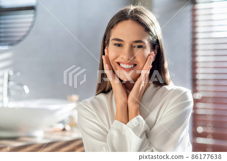 Beauty Care Concept. Portrait of happy beautiful woman posing in modern bathroom Beauty Care Concept. Portrait of happy beautiful woman posing in modern bathroom 86177638