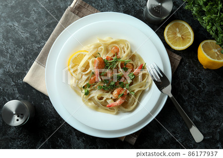 Concept of tasty eating with shrimp pasta on black smokey table Concept of tasty eating with shrimp pasta on black smokey table 86177937