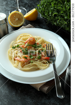 Concept of tasty eating with shrimp pasta on black smokey table Concept of tasty eating with shrimp pasta on black smokey table 86177938