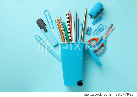 Holder in the form of trash can with stationery on blue background Holder in the form of trash can with stationery on blue background 86177982