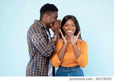 Black Man Sharing News With Excited Woman Whispering To Ear Black Man Sharing News With Excited Woman Whispering To Ear 86178059