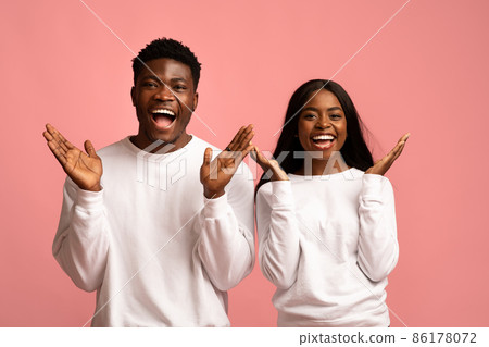 Emotional black couple gesturing on pink background Emotional black couple gesturing on pink background 86178072