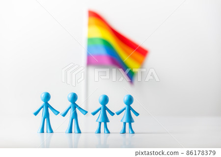 Plastic figures of gay and lesbizn couples and LGBT rainbow flag on light gray background Plastic figures of gay and lesbizn couples and LGBT rainbow flag on light gray background 86178379