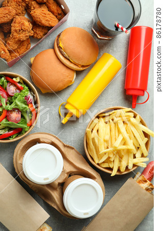 Different fast food on gray textured table 86178780