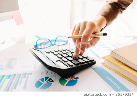 Close up of female accountant or banker making calculations. Savings,  86179334