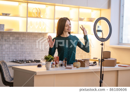 Smiling young beauty coach preparing for going live Smiling young beauty coach preparing for going live 86180606