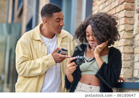 Woman looking at camera and joyful man nearby Woman looking at camera and joyful man nearby 86180647