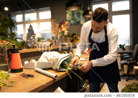 male florist collects luxury bouquet in flower shop male florist collects luxury bouquet in flower shop 86180959