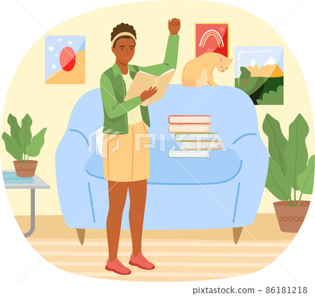 Young woman reading book standing near stack of books in living room, studying at home Young woman reading book standing near stack of books in living room, studying at home 86181218