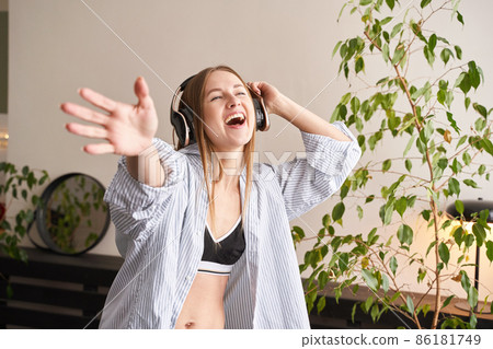 Young woman sing at home. House lyrics dance. Funny song. Independent portrait Young woman sing at home. House lyrics dance. Funny song. Independent portrait 86181749