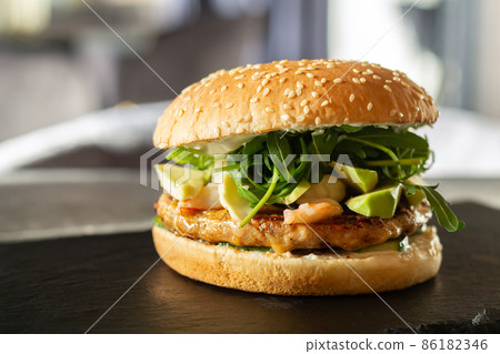 Chicken burger on fast food restaurant table Chicken burger on fast food restaurant table 86182346