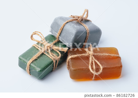 Natural soap bars tied with ribbon isolated on white Natural soap bars tied with ribbon isolated on white 86182726