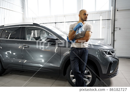 Portrait of African American man, car wash detailing service worker 86182727
