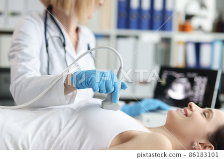Doctor doing ultrasound examination of breast of patient in clinic Doctor doing ultrasound examination of breast of patient in clinic 86183101