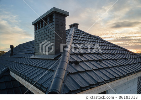 Snow guard for safety in winter on house roof top covered with ceramic shingles. Tiled covering of building Snow guard for safety in winter on house roof top covered with ceramic shingles. Tiled covering of building 86183318