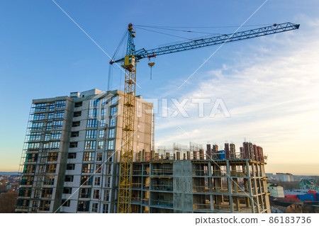 Aerial view of high tower crane and residential apartment buildings under construction. Real estate development. 86183736