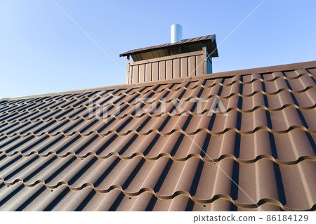 Closeup of house roof top covered with metallic shingles 86184129