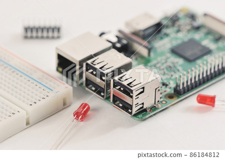 microchip - an electronic board with connectors and a red LED microchip - an electronic board with connectors and a red LED 86184812