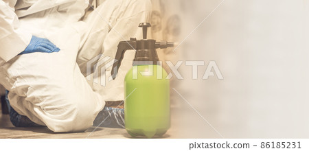 Spray bottle with pesticides close-up. An exterminator in work clothes sprays pesticides from a spray bottle. Fight against insects in apartments and houses. Disinsection of premises Spray bottle with pesticides close-up. An exterminator in work clothes sprays pesticides from a spray bottle. Fight against insects in apartments and houses. Disinsection of premises 86185231