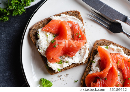 Rye bread toast with cream cheese and salmon Rye bread toast with cream cheese and salmon 86186612