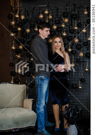 A girl in a beautiful dress hugs and kisses a man A girl in a beautiful dress hugs and kisses a man 86186941