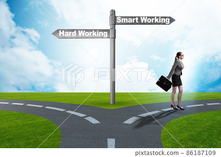 Businesswoman at the crossroads on working smart or hard 86187109