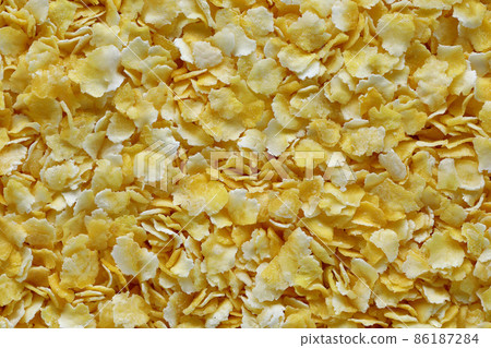 yellow corn grits background macro close up top view 86187284