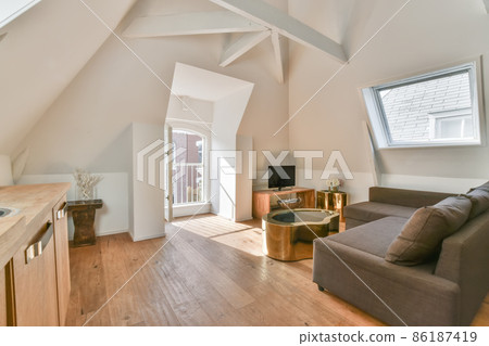 Interior of stylish modern living room with balcony and white walls Interior of stylish modern living room with balcony and white walls 86187419