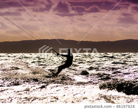 Kite surfer riding waves. Kiteboarding sport. Kite surfer riding waves. Kiteboarding sport. 86187828