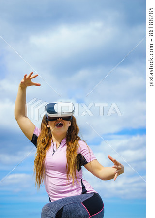 Woman wearing VR outside 86188285