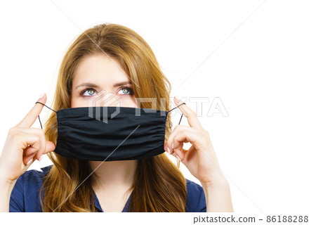 Woman using protective face mask. Woman using protective face mask. 86188288