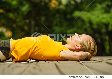 Girl relaxing after exercise gym outdoor Girl relaxing after exercise gym outdoor 86188339