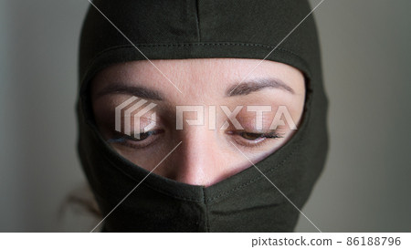 Female portrait of young girl wearing khaki balaclava, only eyes are visible, mandatory conscription, military, feminism, equality concept Female portrait of young girl wearing khaki balaclava, only eyes are visible, mandatory conscription, military, feminism, equality concept 86188796