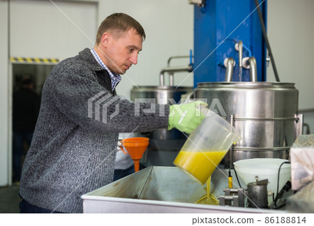 Worker controlling quality of olive oil Worker controlling quality of olive oil 86188814