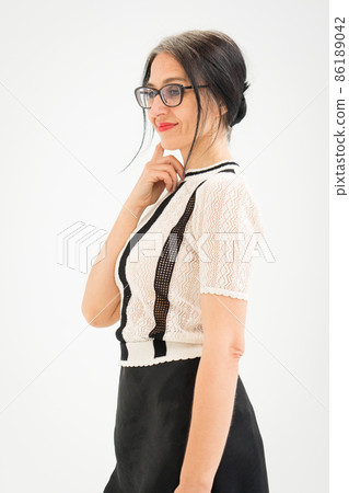 Studio photo of middle aged woman starting getting grey-haired wearing black and white clothes on white background, middle age sexy lady, happy life concept Studio photo of middle aged woman starting getting grey-haired wearing black and white clothes on white background, middle age sexy lady, happy life concept 86189042