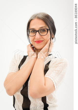 Studio photo of middle aged woman starting getting grey-haired wearing black and white clothes on white background, middle age sexy lady, happy life concept Studio photo of middle aged woman starting getting grey-haired wearing black and white clothes on white background, middle age sexy lady, happy life concept 86189044