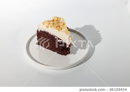 Sliced piece of cake on white background 86189454