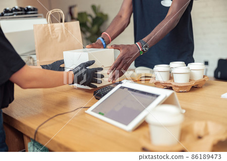 Man and woman holding for white box 86189473