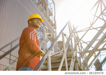 Construction engineer on his job at heavy industry plant Construction engineer on his job at heavy industry plant 86189479