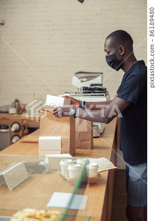 Negro in black mask collecting food orders Negro in black mask collecting food orders 86189480