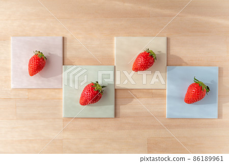 4 strawberries on a colorful bean plate 4 strawberries on a colorful bean plate 86189961