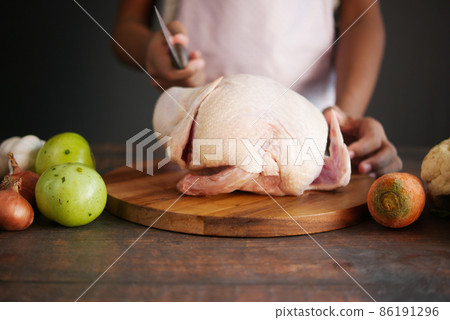 raw whole chicken and vegetables on tiles background  86191296