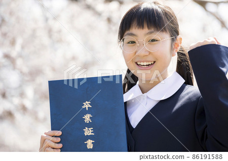 6th grade female elementary school graduation image in uniform wearing a guts pose with a diploma in front of the cherry blossoms 86191588