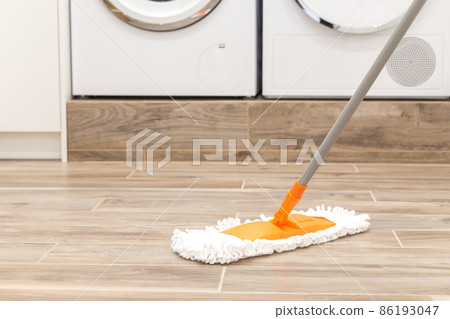 Cleaning floor in laundry room in modern house 86193047